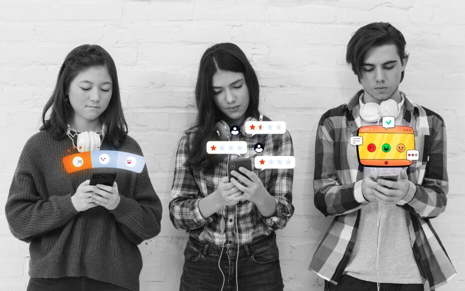 Three teenagers looking at phones and checking their social media accounts.