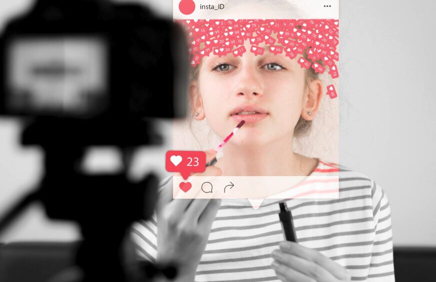 A young girl putting lipstick on while gathering likes on social media