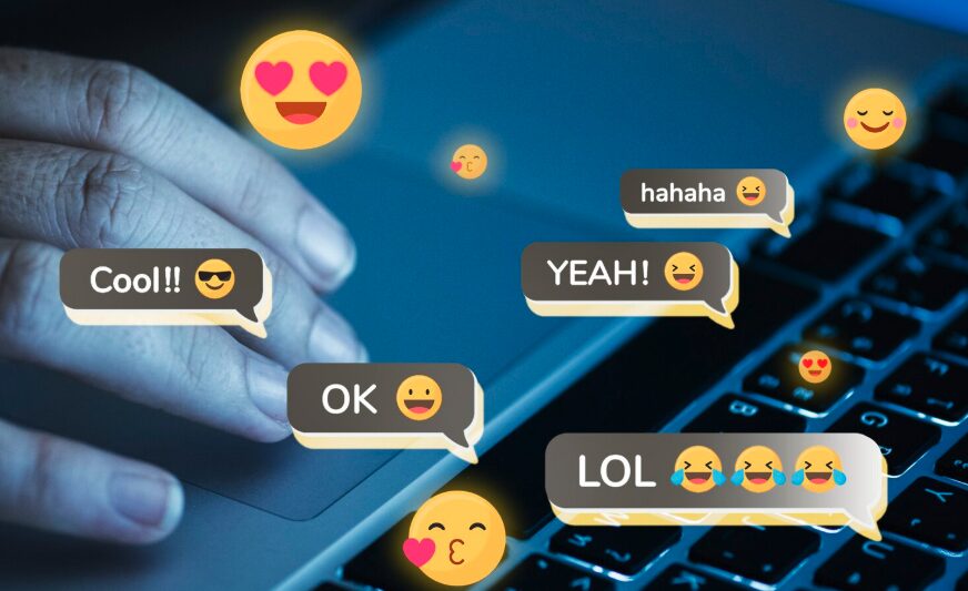 Hand typing on laptop with memes popping out