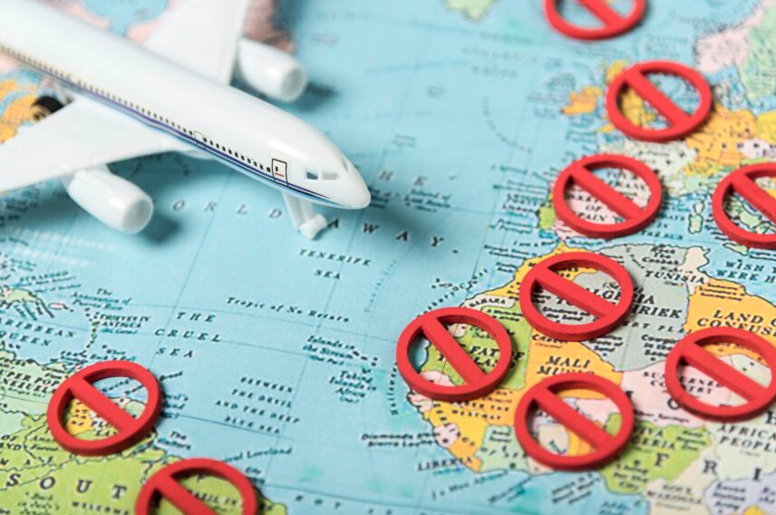 An airplane on the map with closed countries due to lockdown