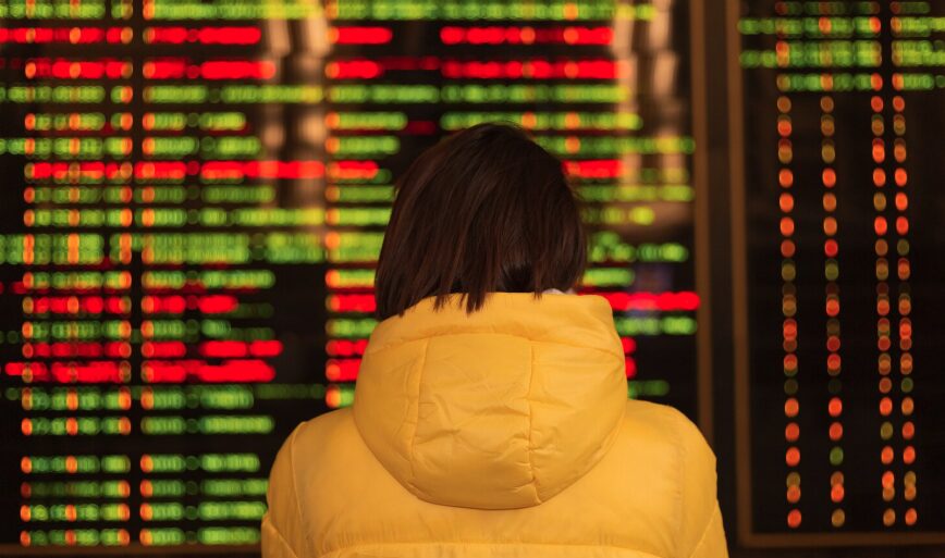 A person looking at a board with flight cancellations announcements