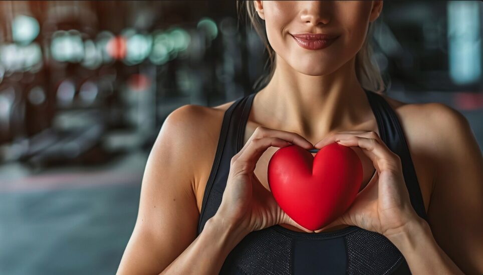 A young woman holding a heart