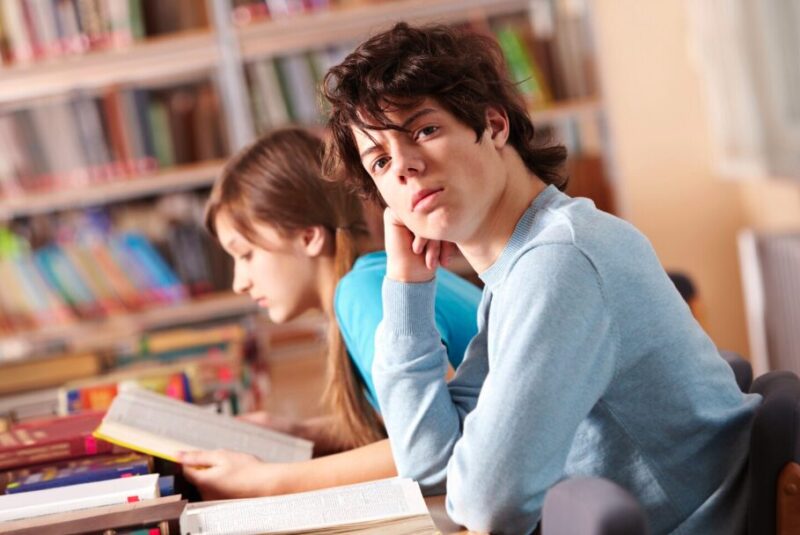 A teenager in library with adhd symptoms