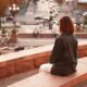 A young woman sitting alone, experiencing the Gen Z loneliness
