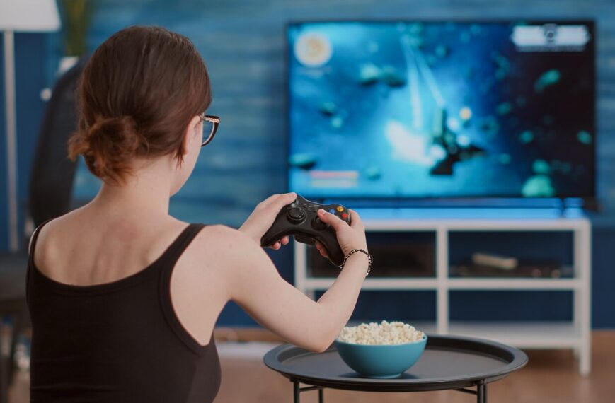 A girl playing video games on TV screen.