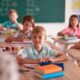 A classroom with children listening to the teacher