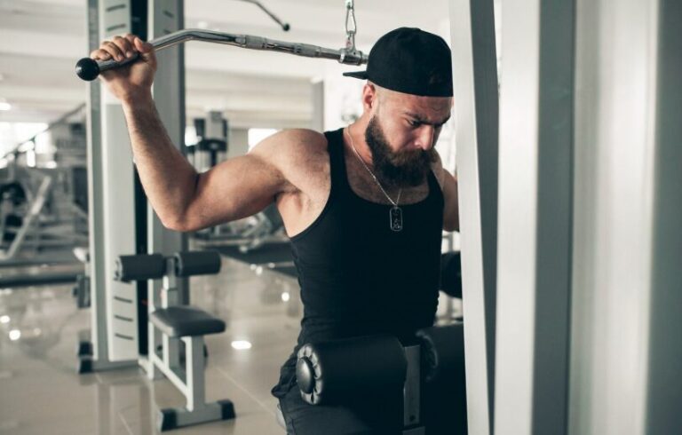 A young man lifting weights at the gym