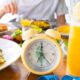 A table with clock and food prepared for ntermittent fasting