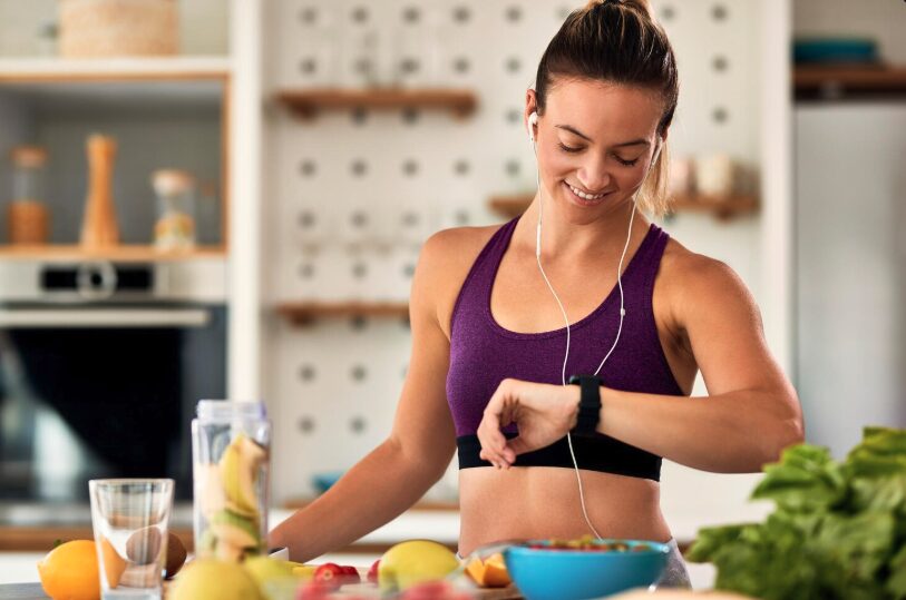 A young woman preparing healthy meal and tracking calories.