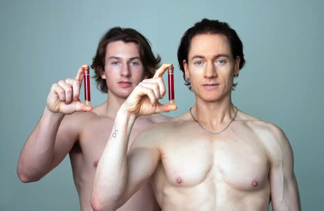 Biohacker Bryan Johnson with his son holding a test tube.