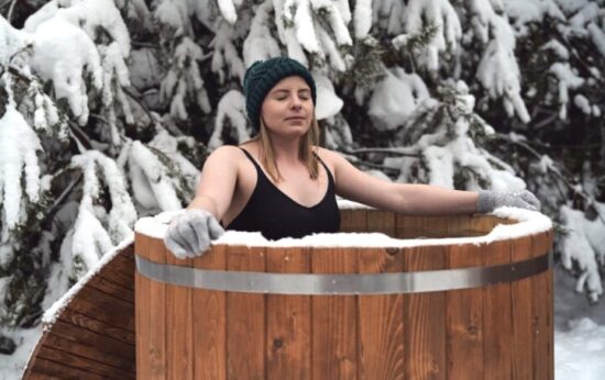 Woman doing a cold plunge in an ice bath